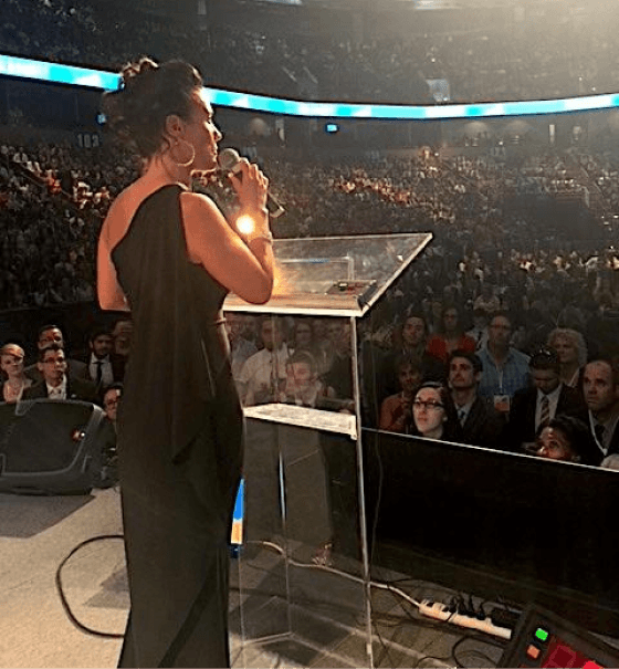 Andrea speaking on stage